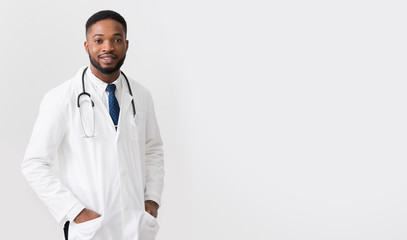 African Doctor In White Uniform Against White Background