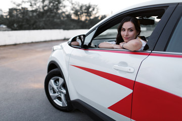 Fototapeta na wymiar Happy young girl with new car. Woman city driver..Business lady motorist