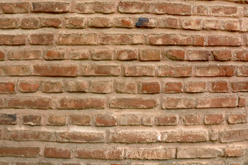 closeup of an old uneven brick wall background texture