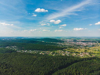 aerial view of the city in the center of green forest