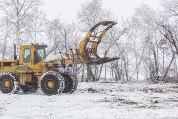 front end loader at work in the snow