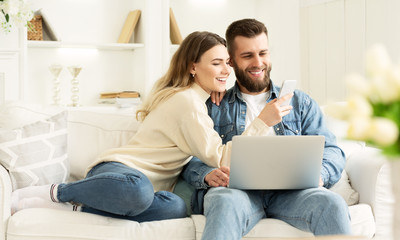 Surfing Internet. Young Couple Relaxing With Laptop - obrazy, fototapety, plakaty