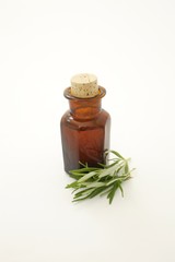 Old-fashioned pharmacy bottle with mixture, rosemary twigs