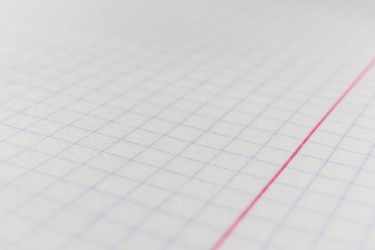 The concept of preparation for school. Sheet of notebook in a cage closeup. Background image for educational themes, school lessons. Background image on the subject of school education.