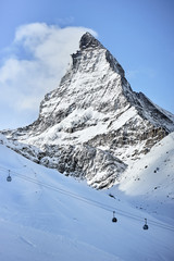 Beautiful view of the Matterhorn from close range with cable cars in the winter on a fine clear snow day      