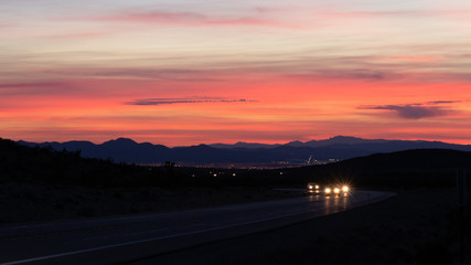 Fototapeta na wymiar Cars on the highway at sunrise in Southern Nevada