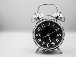 Black retro with silver border alarm clock that represent number of analog on isolated white background