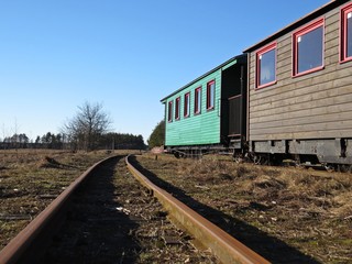 Narrow Gauge Railroad Train Railways Detail Perspective during Day with Historical Colorful Carriages Coaches