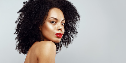 Dark skin model with curly hair fashion portrait.