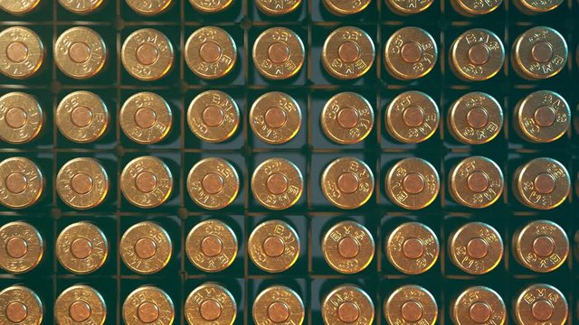 Rows of .50 BMG machine gun ammunition in plastic container. Loop animation.