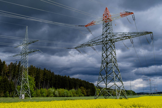 Strommasten im Rapsfeld