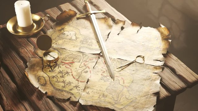 Pirate treasure map with sword compass and candle on wooden table