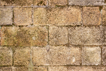 The texture of the old wall of paved worn stone