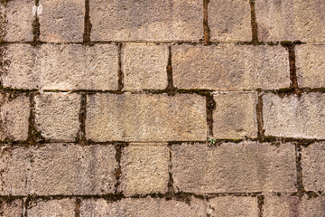 The texture of the old wall of paved worn stone