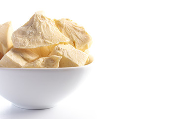 Chunks of Raw Organic Cocoa Butter on a White Background