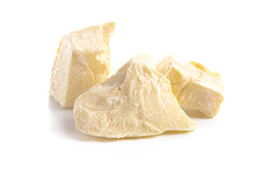 Chunks of Raw Organic Cocoa Butter on a White Background