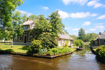 Fototapeta na wymiar View of famous typical Dutch village Giethoorn with canals in the province of 'Overijssel. The beautiful Traditional Dutch House and gardening city is know as 