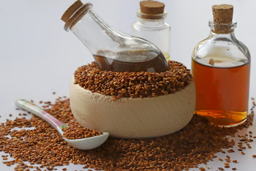 Sesame seeds in bowl and sesame oil in bottle