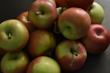 A bunch of red apples on a black background.