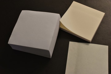 Office paper stickers on black background.