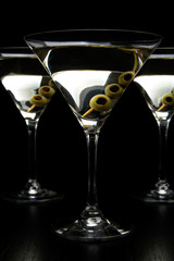 Cropped Vermouth Martini drinks with olives isolated on black