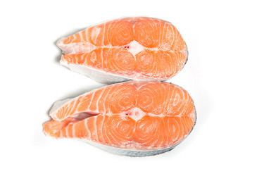 Two salmon steaks on a white background. Cooking sliced red fish meat.