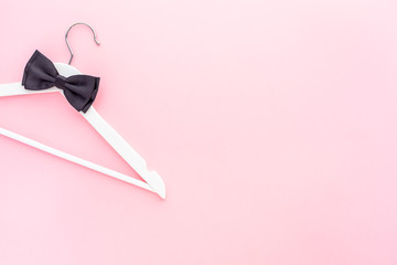 White hangers on pastel pink background