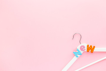 White hangers with sale text on pink background