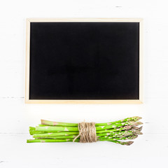 Fresh green asparagus with black chalkboard frame