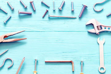 pliers, fasteners, bolts, screws and wrenches, hex wrench screwdriver on turquoise wood background, with speys mines