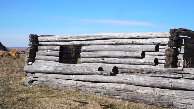 An old rickety dilapidated residential log wooden house