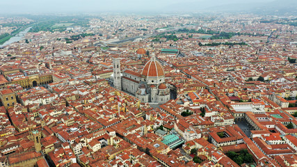 Aerial view of Santa Maria del Fiore Cathedral in Florence, Italy. Orange roofs, hills. Italian...