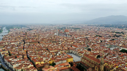 Obraz premium Aerial view of Santa Maria del Fiore Cathedral in Florence, Italy. Orange roofs, hills. Italian Tuscany landscape.
