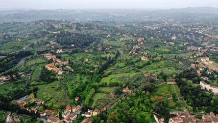 Aerial view of Tuscany landscape in Florence center. Green hills, mountains, cypress trees, orange...