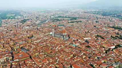 Aerial view of Santa Maria del Fiore Cathedral in Florence, Italy. Orange roofs, hills. Italian Tuscany landscape.