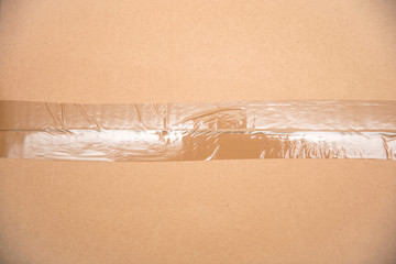 Card board box sealed with transparent packing tape