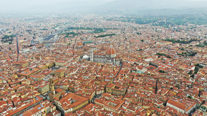 Aerial view of Santa Maria del Fiore Cathedral in Florence, Italy. Orange roofs, hills. Italian Tuscany landscape.