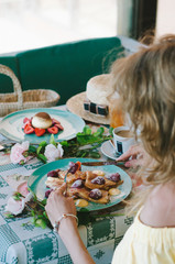 young beautiful woman eating a dessert with strawberries