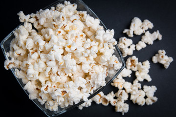 popcorn in a glass bowl on a black background