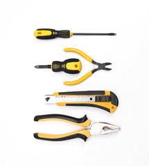Black yellow tools - knife, pliers, tape measure, screwdriver, nippers on a white background. Place for text. Work inventory