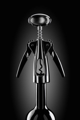 Chrome plated corkscrew on the bottle neck a dark background