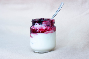 white yogurt in glass jar on table for breakfast
