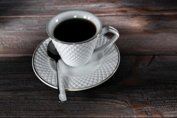Cup of coffee on a dark wooden background