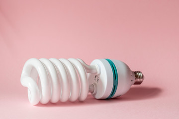 Close up view of white light bulb isolated on pink.