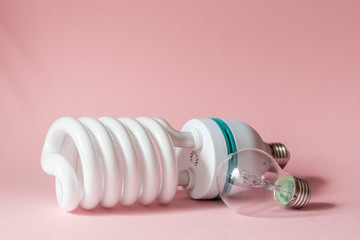 Close up view of white light bulb isolated on pink.