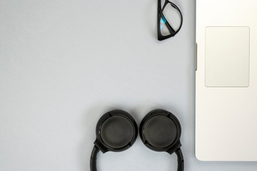 View of office desk with laptop, glasses and other items