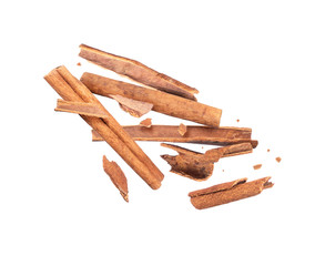 Cinnamon sticks crushed in the air on white background