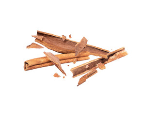 Cinnamon sticks crushed into pieces, frozen in the air on white background