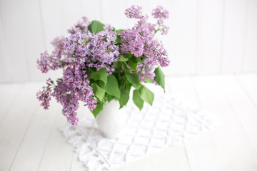 bouquet of lilac on a white background. macrame carpet