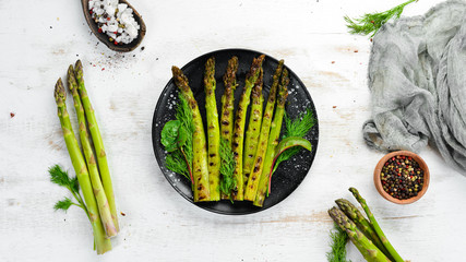 Green asparagus grilled with spices. Healthy food. Top view. Free space for your text.